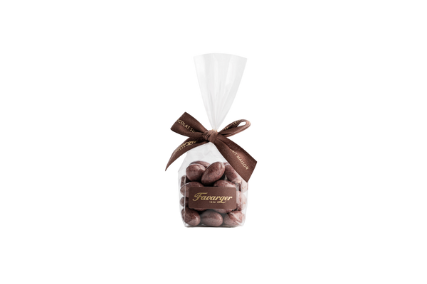 Sachet de 100 g d'amandes Favarger enrobées de chocolat suisse au cassis, alliance gourmande entre le croquant de l'amande et les notes fruitées du cassis.
