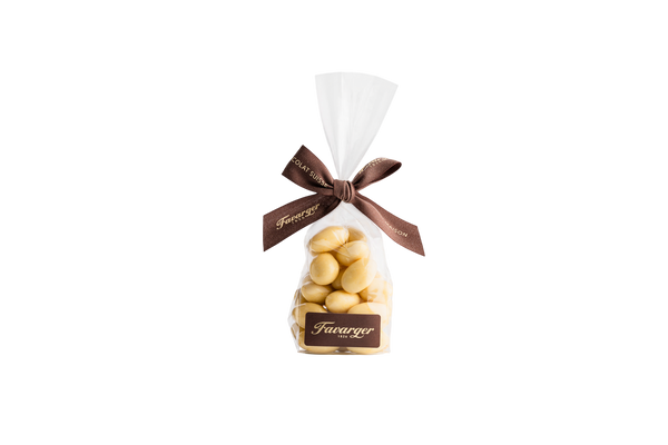 Sachet de 100 g d'amandes Favarger enrobées de chocolat suisse au fruit de la passion, alliance gourmande entre le croquant de l'amande et les notes exotiques du fruit de la passion.